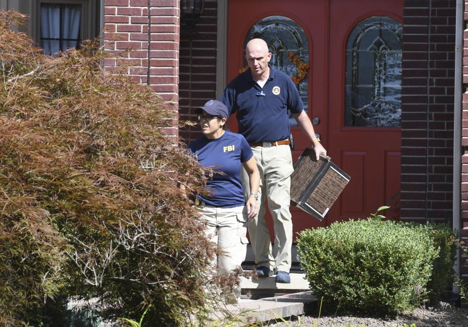 FBI investigators leave the home of UAW President Gary Jones during a search on Wednesday, August 28, 2019 in Canton, Michigan. (Max Ortiz/Detroit News via AP)