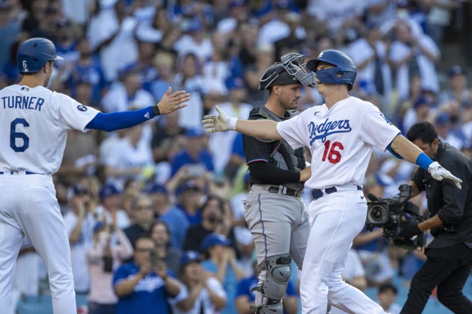 The Dodgers' Will Smith (16) is congratulated by teammate Trea Turner after Smith hit a three-run homer Aug. 20, 2022.