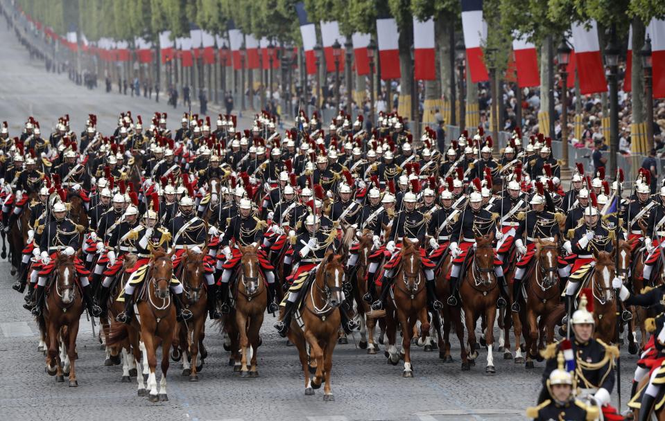 Republican Guards march on the Champs-Elysees avenue during the Bastille Day parade in Paris, France, Sunday July 14, 2019. (AP Photo/Michel Euler)