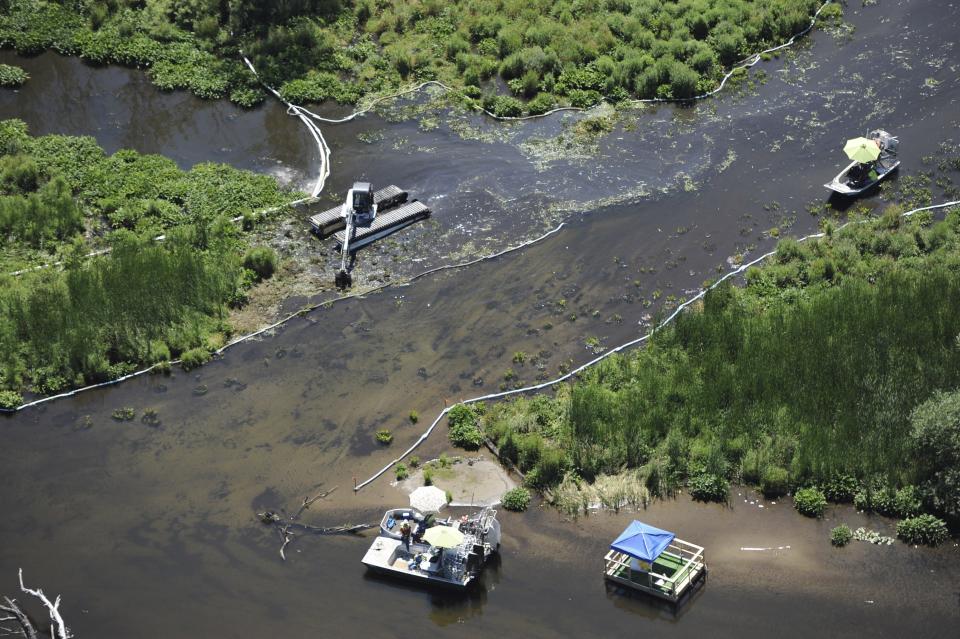 FILE- In a July 13, 2011, file photo, cleanup work continues on the Kalamzoo River almost a year after a spill near Marshall, Mich. U.S. transportation officials have finalized long-delayed measures meant to prevent pipeline spills and deadly gas explosions but don't address recommended steps to lessen accidents once they occur. (AP Photo/Joe Raymond, File)