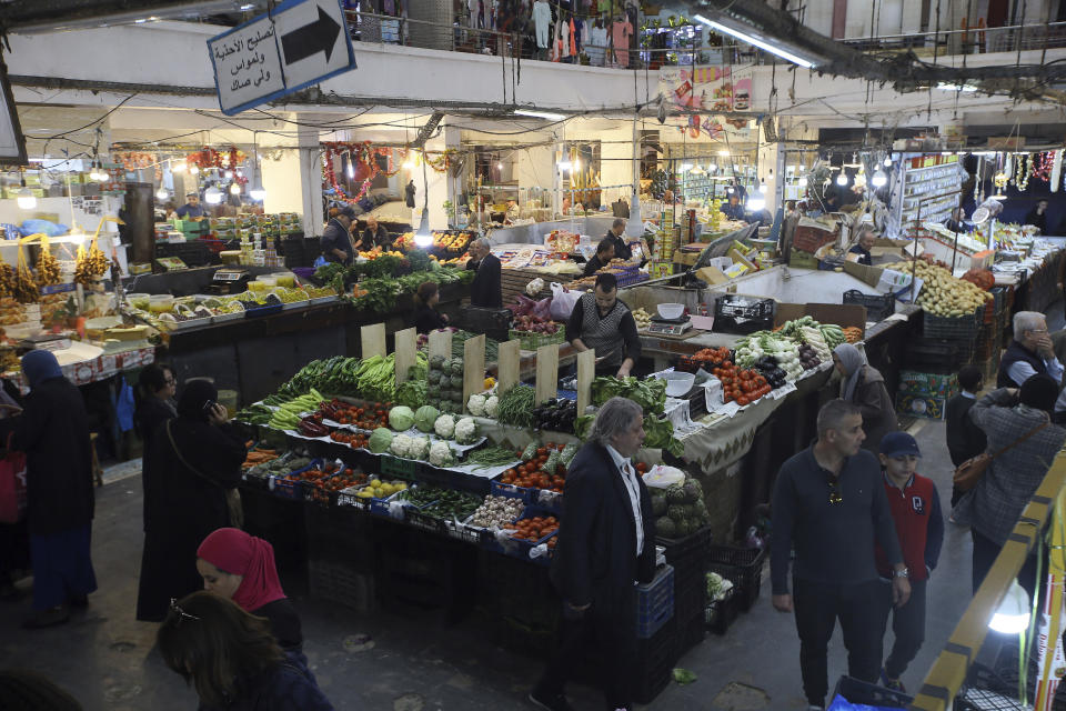 Customers shop at a market near Algiers, Tuesday, March 26, 2024. As Muslim-majority countries reckon with increased demand throughout Islam's holy month of Ramadan, is trying to flood new markets with pantry staples to stave off shortages that can cause prices to rise. (AP Photo/Anis Belghoul)