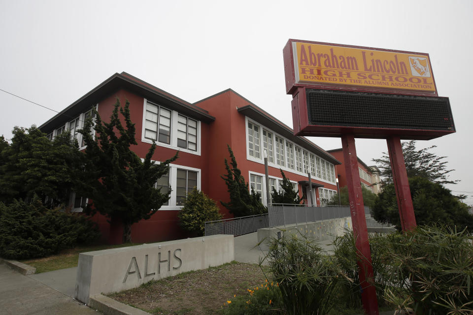 FILE - In this March 12, 2020, file photo, Abraham Lincoln High School stands in San Francisco. The San Francisco school board has voted to remove the names of George Washington and Abraham Lincoln from public schools after officials deemed them and other prominent figures, including Sen. Dianne Feinstein unworthy of the honor. After months of controversy, the board voted 6-1 Tuesday, Jan. 26, 2021, in favor of renaming 44 San Francisco school sites with new names with no connection to slavery, oppression, racism or similar criteria, the San Francisco Chronicle reported. (AP Photo/Jeff Chiu, File)