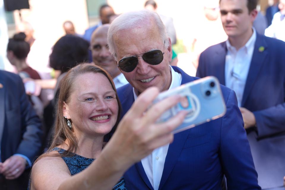 Biden takes a photo with a supporter at a campaign rally in Harrisburg (AP)