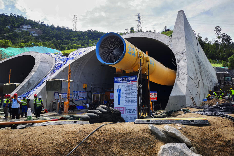 Rescuers work on a flooded tunnel in Zhuhai city in south China's Guangdong province Friday, July 16, 2021. Divers have been dispatched in the search for 14 workers missing since water flooded a tunnel under construction in southern China three days ago, authorities said Sunday, July 18, 2021. (Chinatopix via AP)