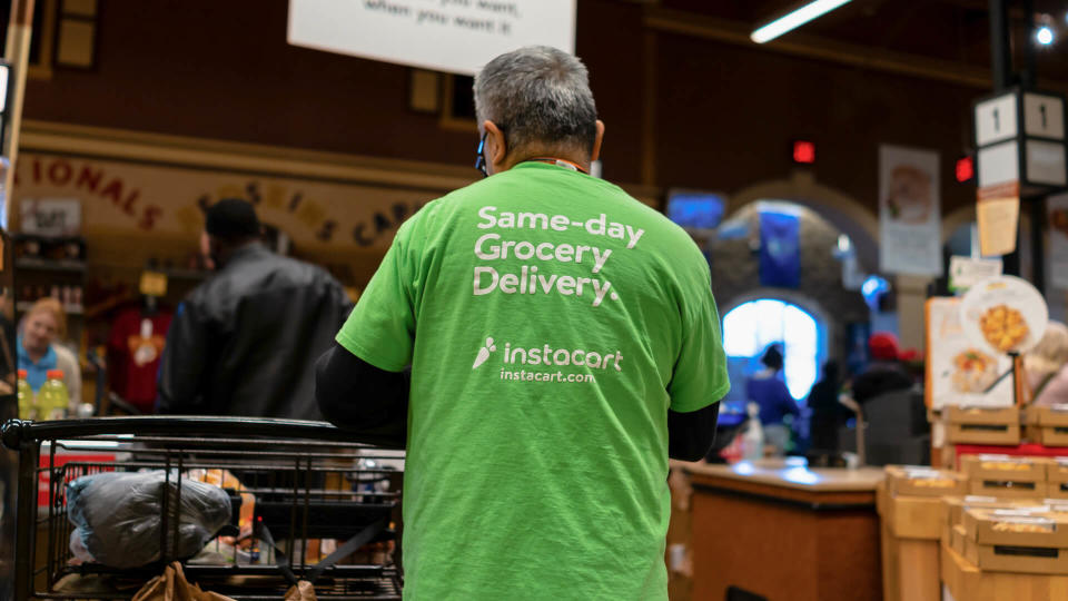 Fairfax, USA - December 5, 2019: Wegmans grocery store interior with Instacart man worker and sign on shirt for same-day delivery.