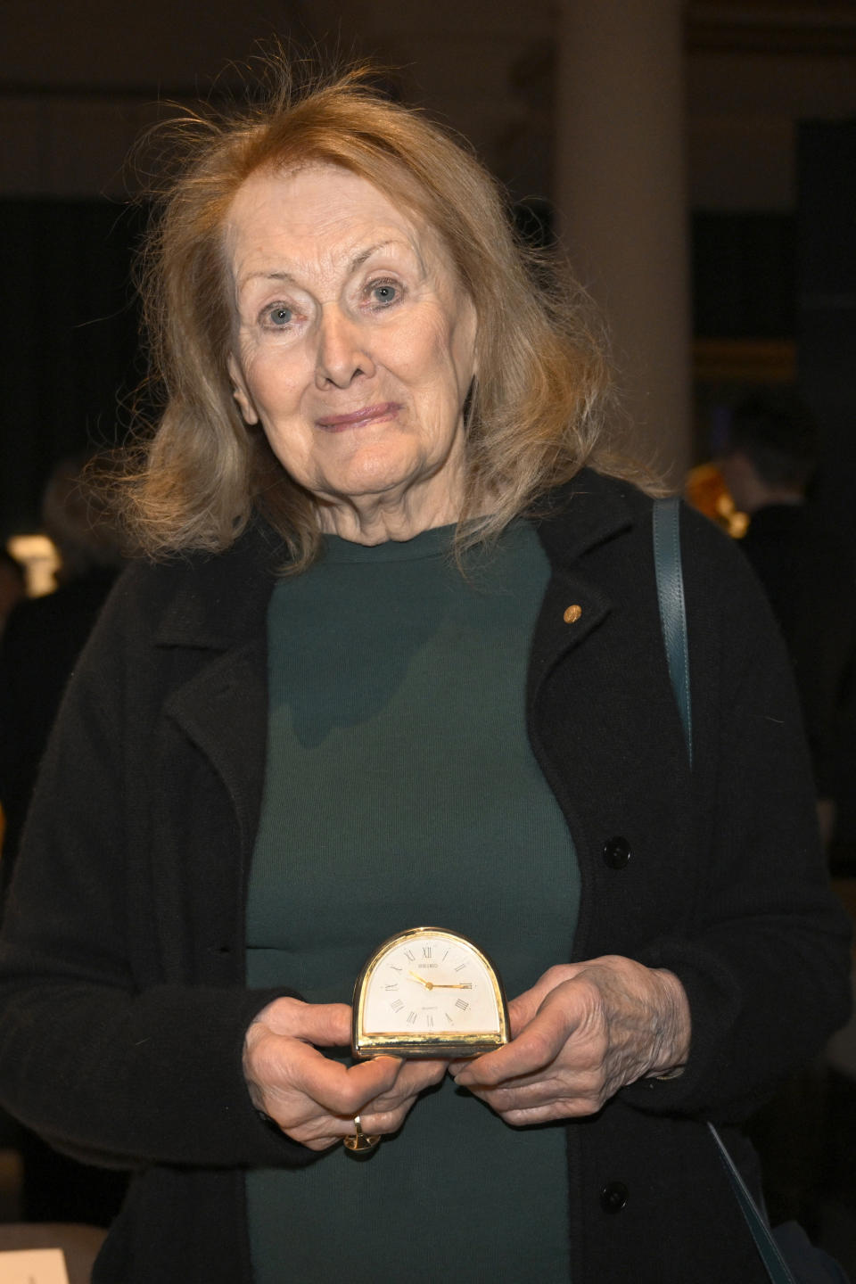 French writer Annie Ernaux, winner of the 2022 Nobel Prize in Literature, poses for a photograph holding her alarm clock from when she wrote the book "The Years" which she will donate to the Nobel Prize Museum in Stockholm, Tuesday, Dec. 6, 2022. The Nobel prize recipients, all but the Peace Prize which is handed out in neighboring Norway, will receive the coveted awards during a ceremony Saturday at the Stockholm Concert Hall attended by Sweden’s royal family. (Jessica Gow/TT News Agency via AP)