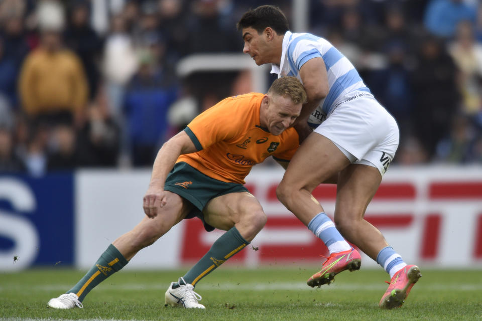 Argentina's Santiago Carreras is tackled by Australia's Reece Hodge during their rugby championship match, in Mendoza, Argentina, Saturday, Aug. 6, 2022. (AP Photo/Gustavo Garello)