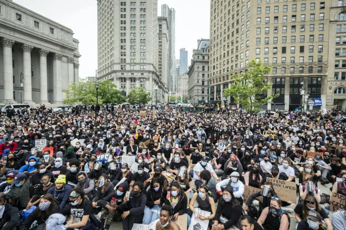 <span class="caption">In this June 2020 photograph, a massive group of protesters is seated on the ground in New York City in a peaceful protest of the killing of George Floyd.</span> <span class="attribution"><a class=