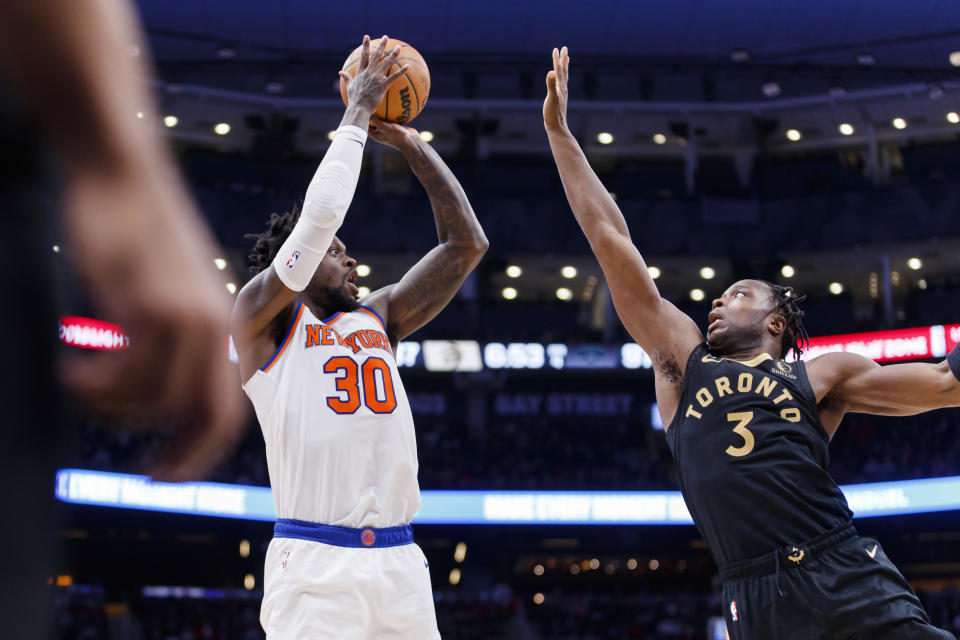 New York Knicks forward Julius Randle (30) shoots over Toronto Raptors forward O.G. Anunoby (3) during the second half of an NBA basketball game Friday, Jan. 6, 2023, in Toronto. (Cole Burston/The Canadian Press via AP)