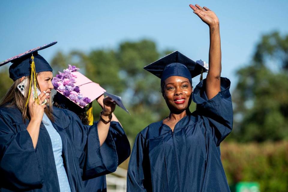 Graduate Latonya Gibson of Las Vegas waves to the stands during a commencement ceremony for the Merced College class of 2022 on the Don Odishoo Field at Stadium ’76 in Merced, Calif., on Friday, May 20, 2022.