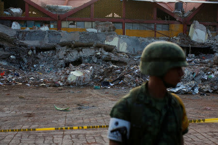 A soldier stands in front of the rubbles of a part of the municipal palace, after an earthquake struck the southern coast of Mexico late on Thursday, in Juchitan, Mexico, September 9, 2017. REUTERS/Carlos Jasso