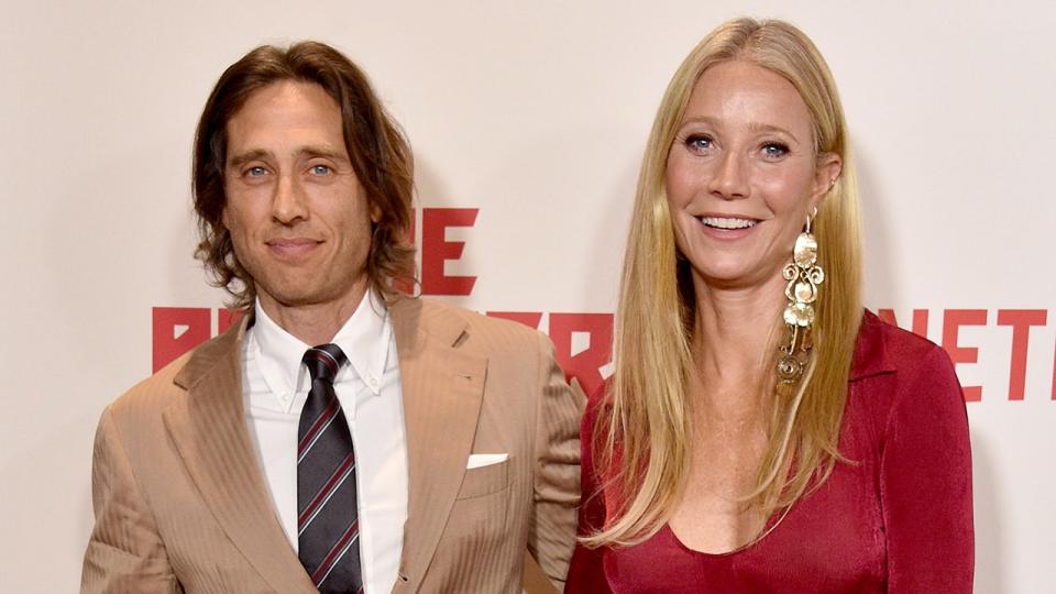 Brad Falchuk sports tan suit alongside Gwyneth Paltrow in red dress