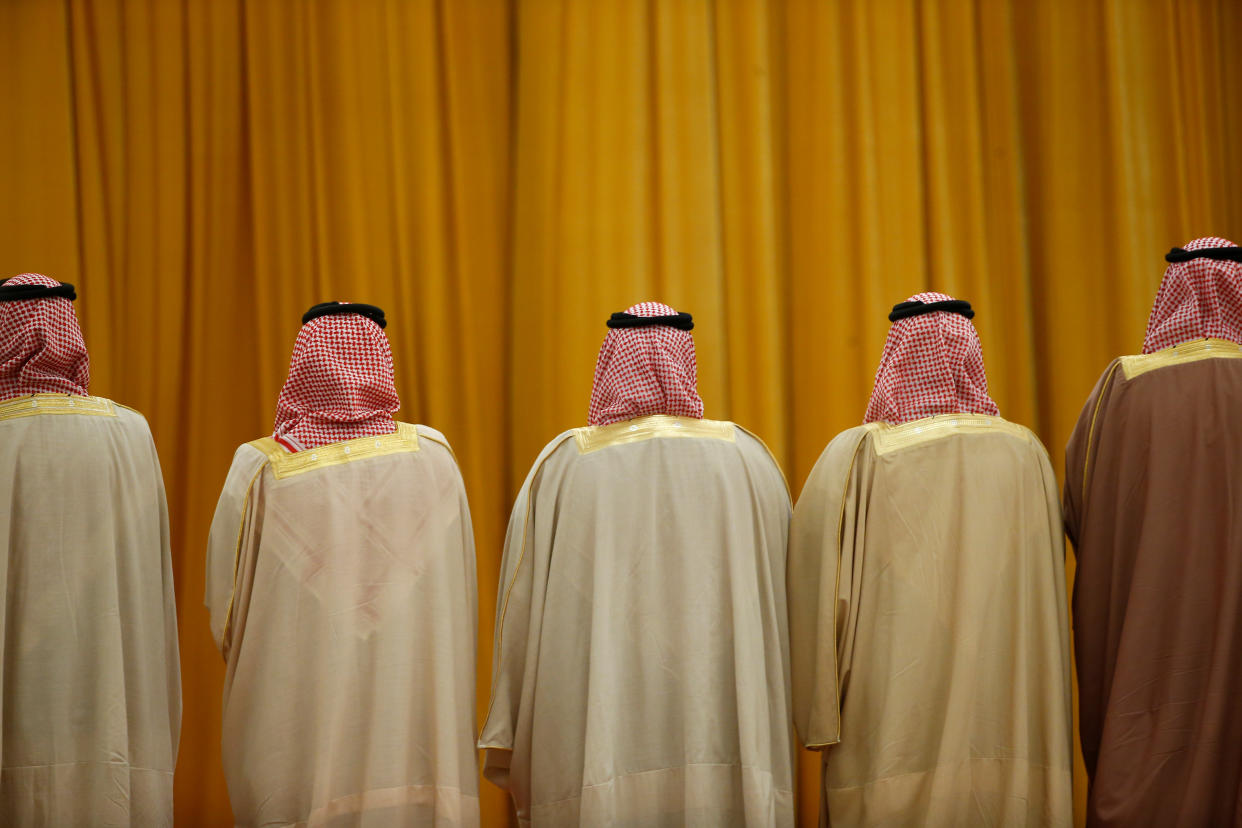 Members of the Saudi delegation wait for the arrival of China's President Xi Jinping and Saudi King Salman bin Abdulaziz Al-Saud before a welcoming ceremony at the Great Hall of the People in Beijing, China, March 16, 2017. REUTERS/Thomas Peter