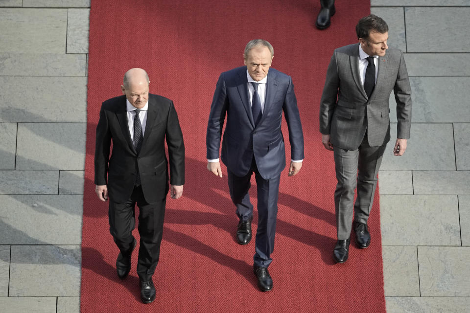 German Chancellor Olaf Scholz, Poland's Prime Minister Donald Tusk and French President Emmanuel Macron, from left, walk on a red carpet during military honors in Berlin, Germany, Friday, March 15, 2024. German Chancellor Olaf Scholz, France's President Emmanuel Macron and Poland's Prime Minister Donald Tusk meet in Berlin for the so-called Weimar Triangle talks. (AP Photo/Markus Schreiber)