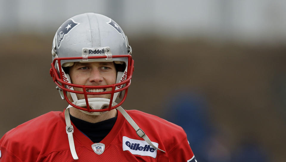 New England Patriots quarterback Tom Brady (12) smiles during a drills and stretching session before practice begins at the NFL football team's facility in Foxborough, Mass., Thursday, Jan. 16, 2014. The Patriots will play the Denver Broncos in the AFC Championship game Sunday in Denver. (AP Photo/Stephan Savoia)