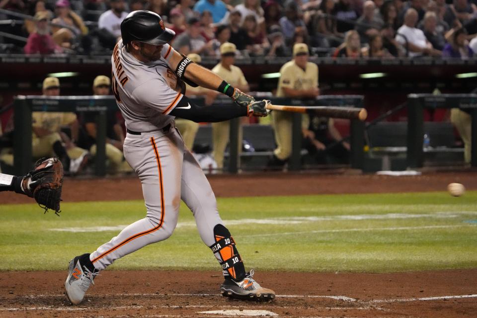 Sep 23, 2022; Phoenix, Arizona, USA; San Francisco Giants third baseman Evan Longoria (10) hits an RBI single against the Arizona Diamondbacks during the fifth inning at Chase Field.