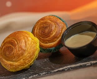 Polystarch Puffbread: Croissants topped with blue and green milk craquelin served with yuzu-passion fruit-coconut dipping sauce