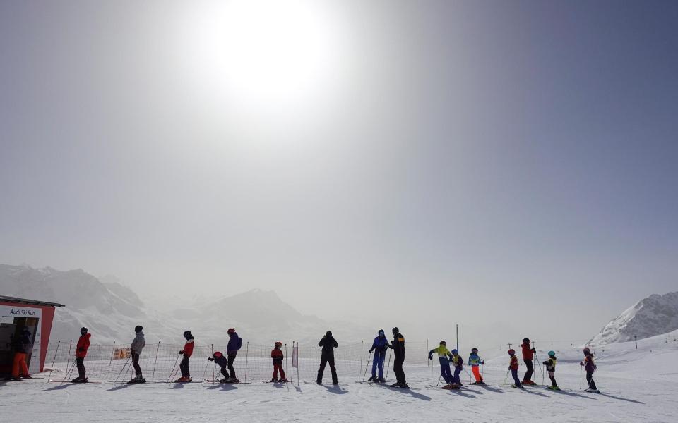 Sahara dust on skiers -  ARND WIEGMANN/REUTERS