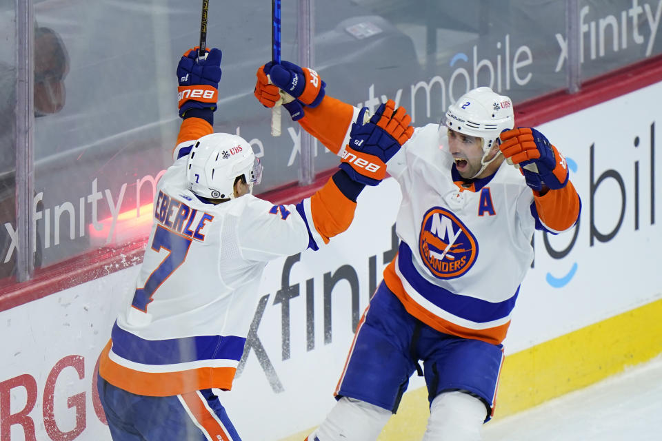 New York Islanders' Nick Leddy, right, and Jordan Eberle celebrate after Leddy scored the game-winning goal during overtime in an NHL hockey game against the Philadelphia Flyers, Sunday, April 18, 2021, in Philadelphia. (AP Photo/Matt Slocum)