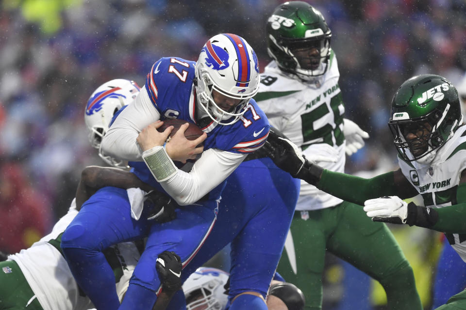 Buffalo Bills quarterback Josh Allen (17) advances toward the end zone for a touchdown as New York Jets linebacker C.J. Mosley, right, tries to defend during the second half of an NFL football game, Sunday, Dec. 11, 2022, in Orchard Park, N.Y. (AP Photo/Adrian Kraus)