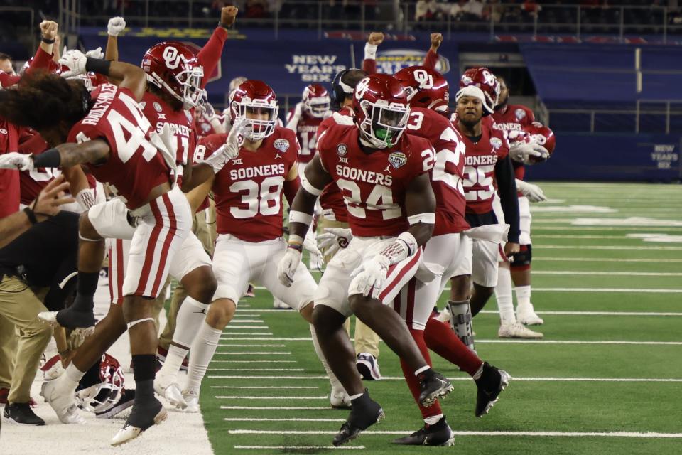 FILE - Oklahoma team members on the sideline celebrate with linebacker Brian Asamoah (24) after Asamoah tackled Florida wide receiver Rick Wells short of the end zone on a fourth-down play in the second half of the Cotton Bowl NCAA college football game in Arlington, Texas, in this Wednesday, Dec. 30, 2020, file photo. Oklahoma is No. 2 in The Associated Press Tlop 25 preseason college football poll released Monday, Aug. 16, 2021. (AP Photo/Michael Ainsworth, File)