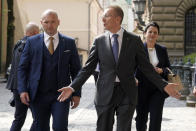 Newly elected Latvian President Edgars Rinkevics, centre, gestures as he walks outside of the parliament building after lawmakers elected him in Riga, Latvia, Wednesday, May 31, 2023. (AP Photo/Roman Koksarov)