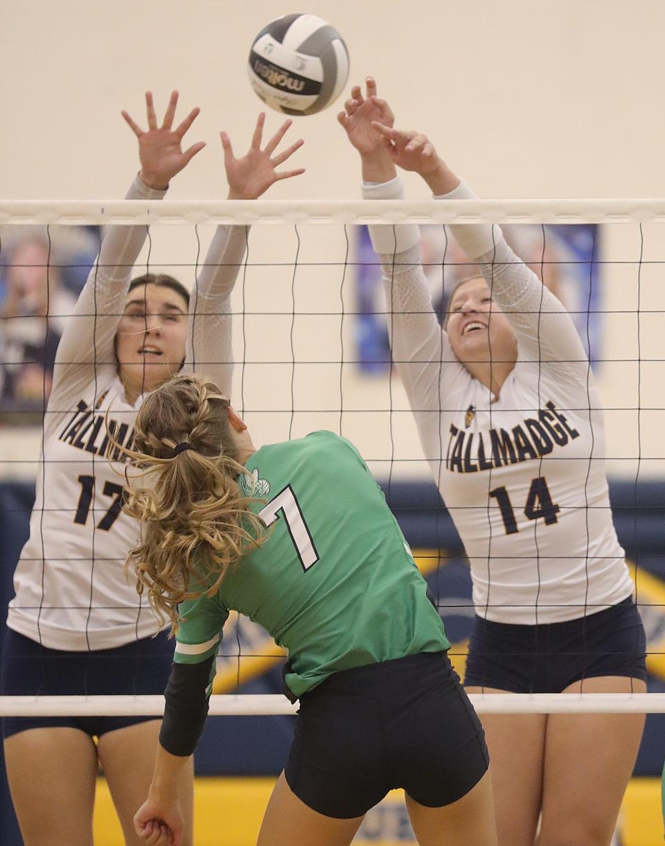 Tallmadge's Kari Kurko, left, and Zoe Rensel go up to block a hit at the net by Highland's Kallan Hrics on Tuesday, Aug. 30, 2022 in Tallmadge.