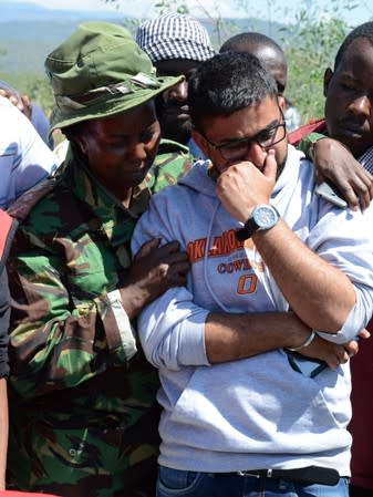 People mourn as Kenya Red Cross workers and volunteers retrieve the bodies of their relatives who died in a flash floods while on an excursion at the Hell's Gate National Park in Naivasha