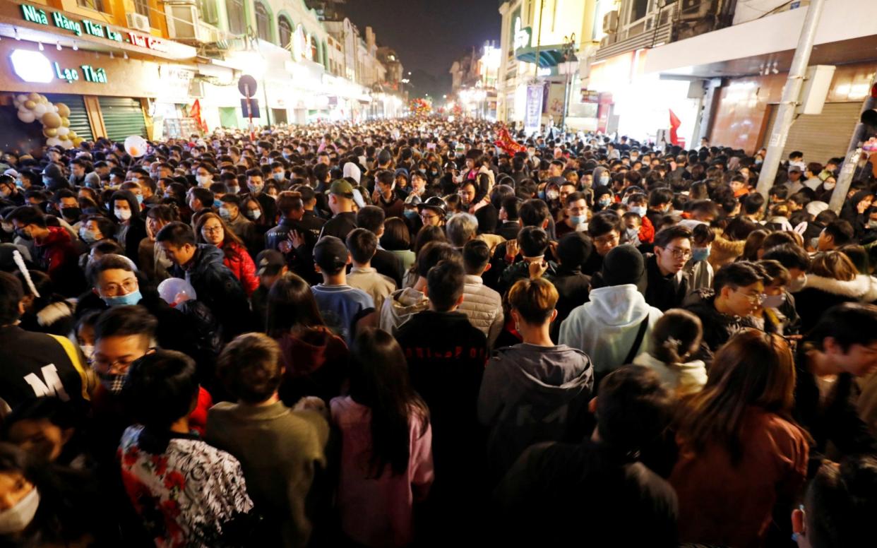 People gather on a street during New Year's Eve celebrations amid coronavirus pandemic in Hanoi - Reuters