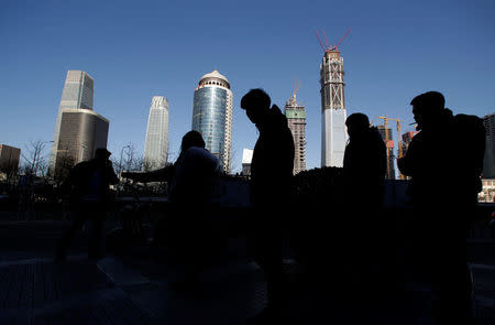 Pedestrians walk outside an office building in Beijing's central business area, China, January 20, 2017. REUTERS/Jason Lee