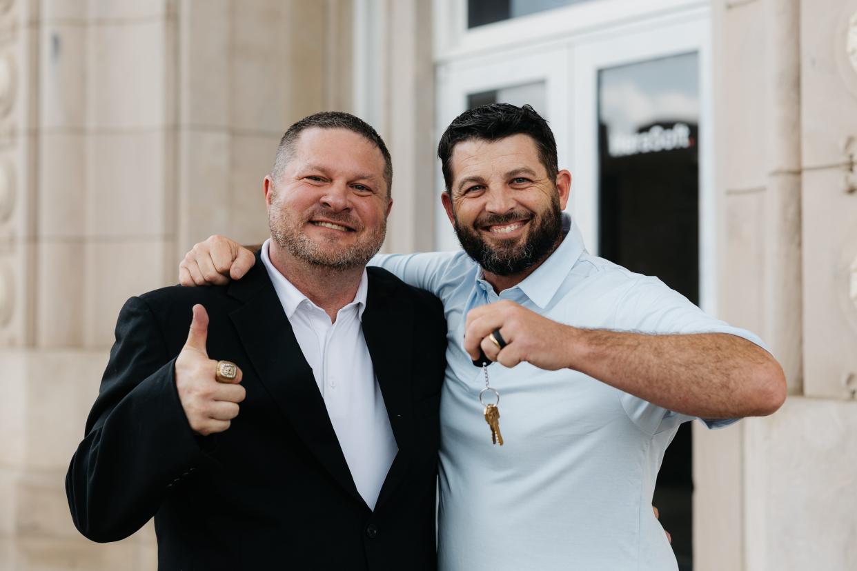 (Left to right) Bryan and Dallas Hindman hold up the keys their newly acquired property, the historic and former Washington County Courthouse located in downtown Bartlesville.