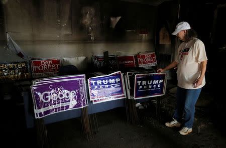 Evelyn Poole-Kober views the damage caused in an arsonist attack on local offices of the North Carolina Republican Party in Hillsborough, North Carolina, U.S. October 17, 2016. REUTERS/Chris Keane/File Photo