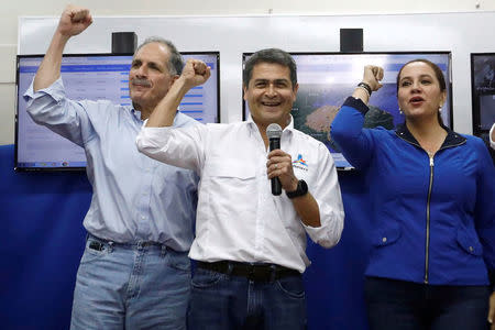 Honduras President and National Party candidate Juan Orlando Hernandez (C) gestures with Tegucigalpa's mayor Nasry Asfura and his wife Ana Garcia de Hernandez at National Party center in Tegucigalpa, Honduras, November 26, 2017. REUTERS/Edgard Garrido