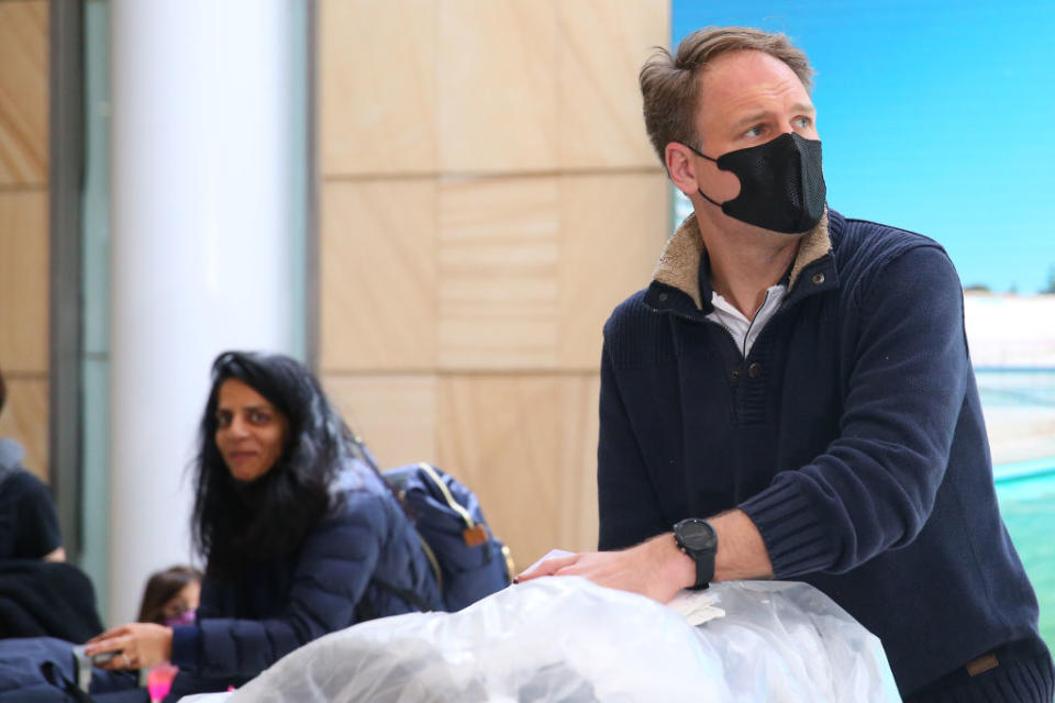 All passengers arriving from overseas must now self-isolate for 14 days. Pictured is man returning to Sydney earlier this year. Source: Getty