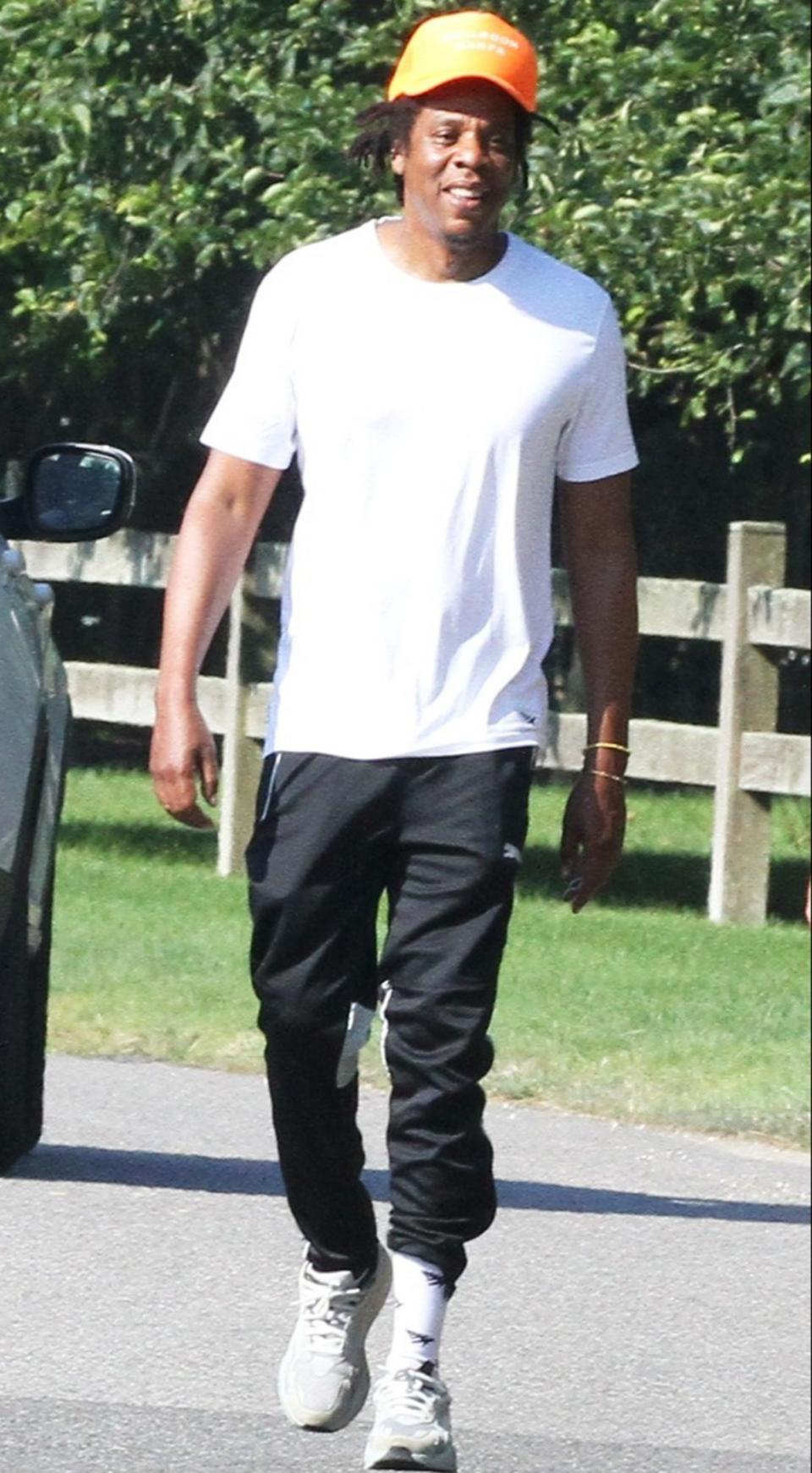 <p>JAY-Z takes a walk through The Hamptons, New York, wearing a white tee and track pants on Wednesday.</p>