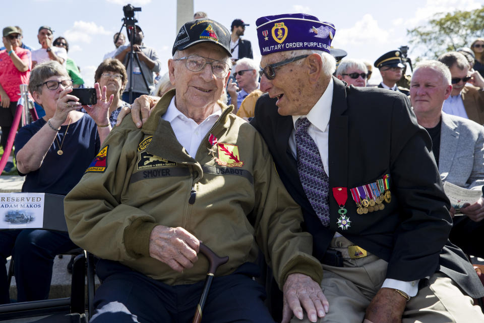 World War II veterans Clarence Smoyer, 96, left, and Joseph Caserta smile after Smoyer was presented the Bronze Star at the World War II Memorial, Wednesday, Sept. 18, 2019, in Washington. Smoyer fought with the U.S. Army's 3rd Armored Division, nicknamed the Spearhead Division. In 1945, he defeated a German Panther tank near the cathedral in Cologne, Germany — a dramatic duel filmed by an Army cameraman that was seen all over the world. (AP Photo/Alex Brandon)