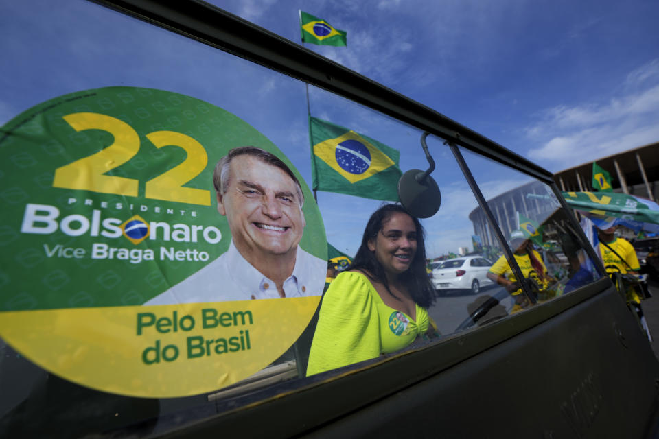 A supporter of Brazil's President Jair Bolsonaro, who is running for reelection, attends a campaign event in Brasilia, Brazil, Saturday, Oct. 29, 2022. Bolsonaro is facing former President Luiz Inacio Lula da Silva in a runoff election set for Oct. 30. (AP Photo/Eraldo Peres)