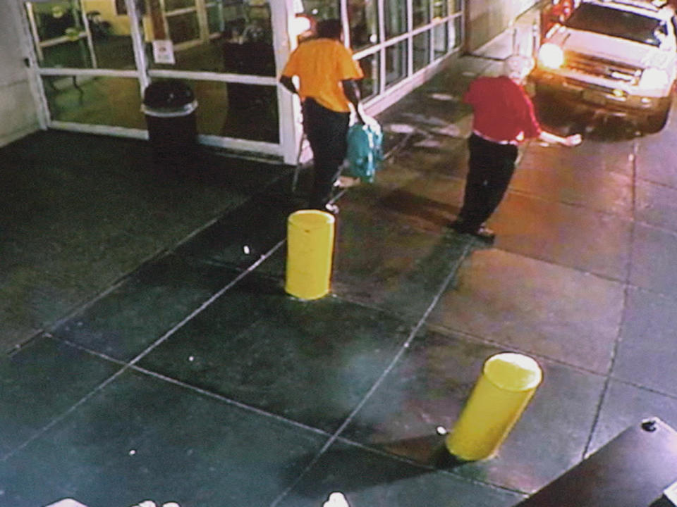 Hospital surveillance footage shows the SUV driven by Dani Jo Carter arriving at Emory's emergency entrance. Tex McIver can be see upper right in the red shirt.  / Credit: Superior Court of Fulton County.