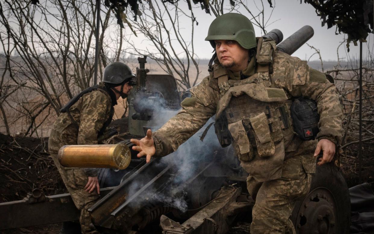 Ukrainian soldiers fire a M101 howitzer at Russian positions on the front line, near the city of Avdiivka in the Donetsk region