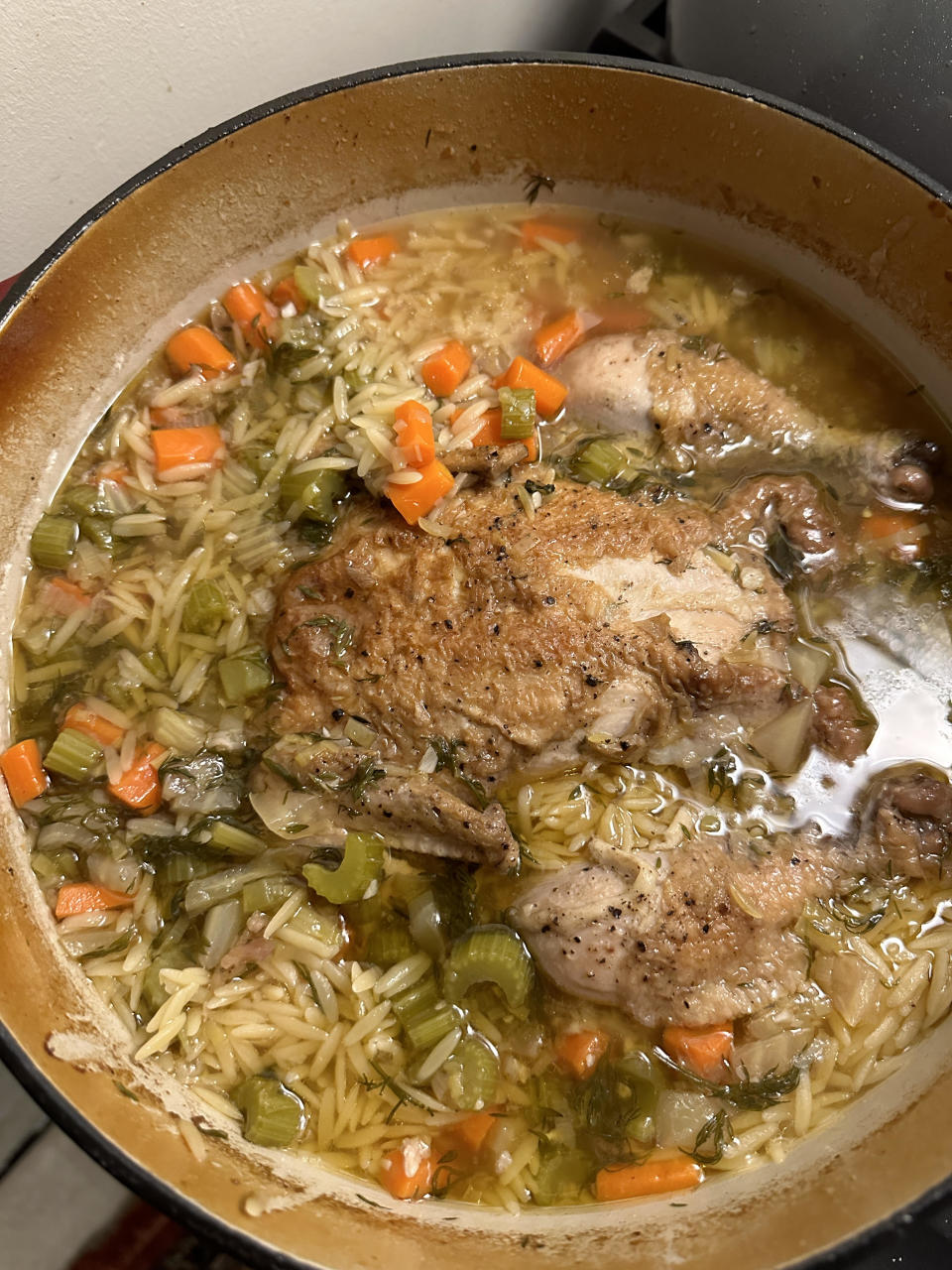 Chicken orzo soup cooking in a pot