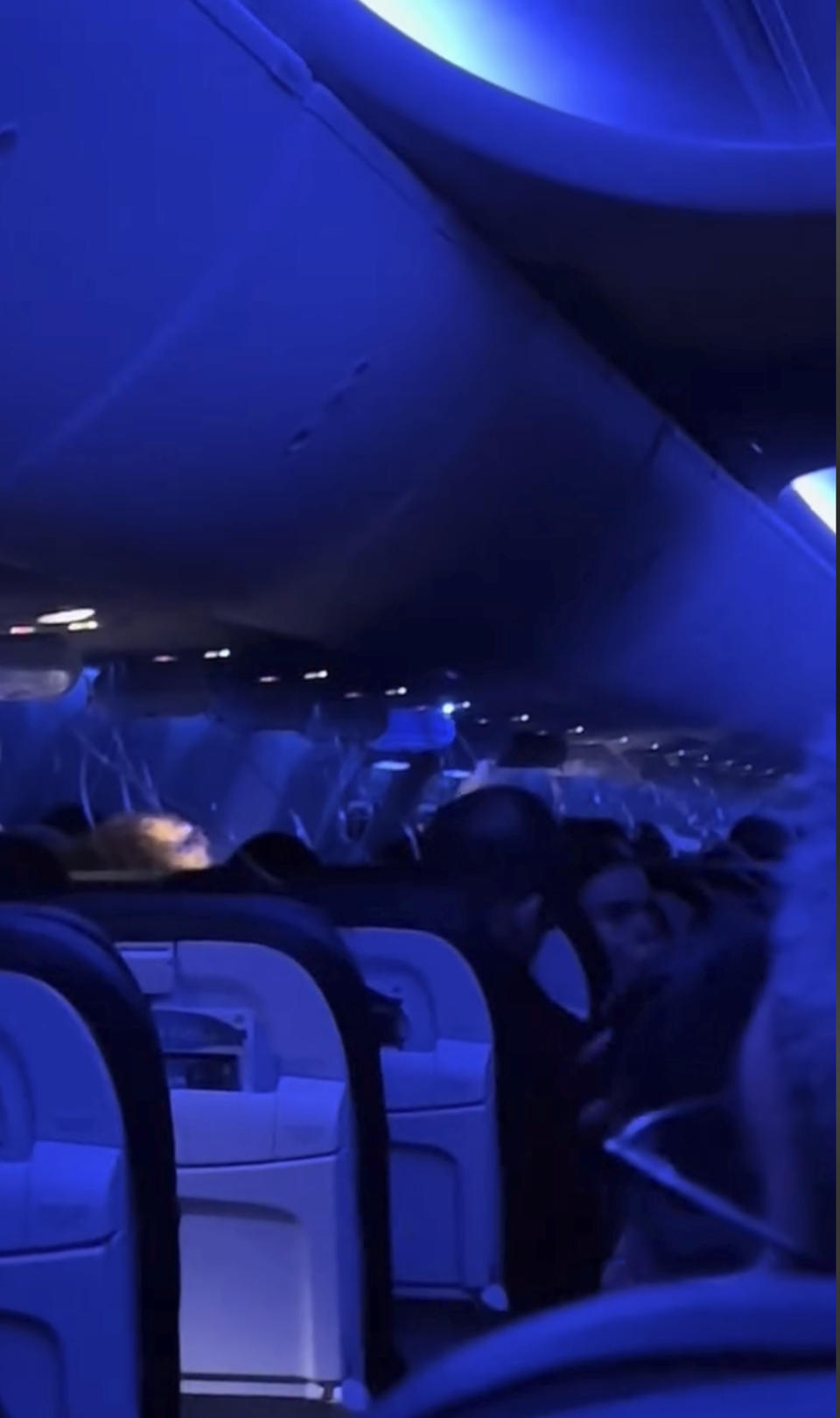 This image from video provided by Elizabeth Le shows passengers using oxygen masks after damage on an Alaska Airlines Boeing 737 Max 9, Flight 1282, which was forced to return to Portland International Airport on Friday, Jan. 5, 2024. (Elizabeth Le via AP)