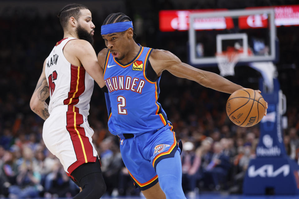 Oklahoma City Thunder guard Shai Gilgeous-Alexander (2) drives against Miami Heat forward Caleb Martin, left, during the second half of an NBA basketball game Friday, March 8, 2024, in Oklahoma City. (AP Photo/Nate Billings)