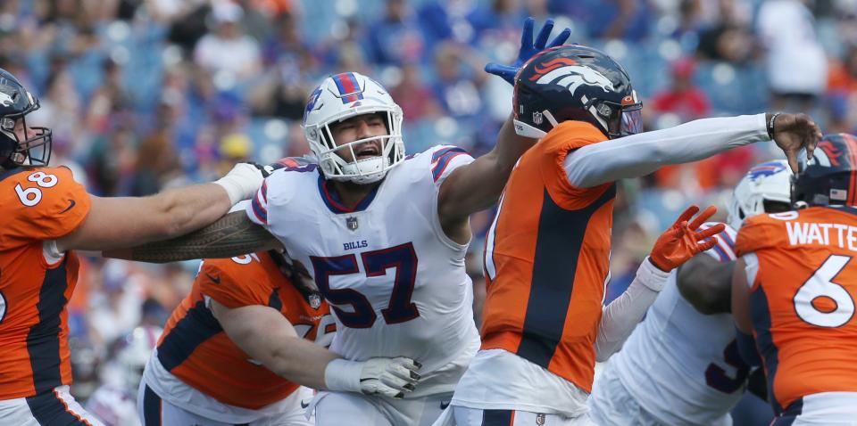 Bills defensive end A.J. Epenesa (57) fights through the Denver line to pressure Broncos quarterback Josh Johnson (11), right, during the Bills preseason game against Denver Saturday, Aug. 20, 2022 at Highmark Stadium.  Buffalo won the game 42-15.