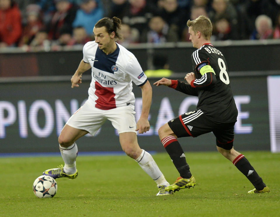 Leverkusen's Lars Bender, right, and PSG's Zlatan Ibrahimovic challenge for the ball during a Champions League round of the last 16 first leg soccer match between Bayer Leverkusen and Paris Saint-Germain in Leverkusen, Germany, Tuesday Feb. 18, 2014. (AP Photo/Martin Meissner)