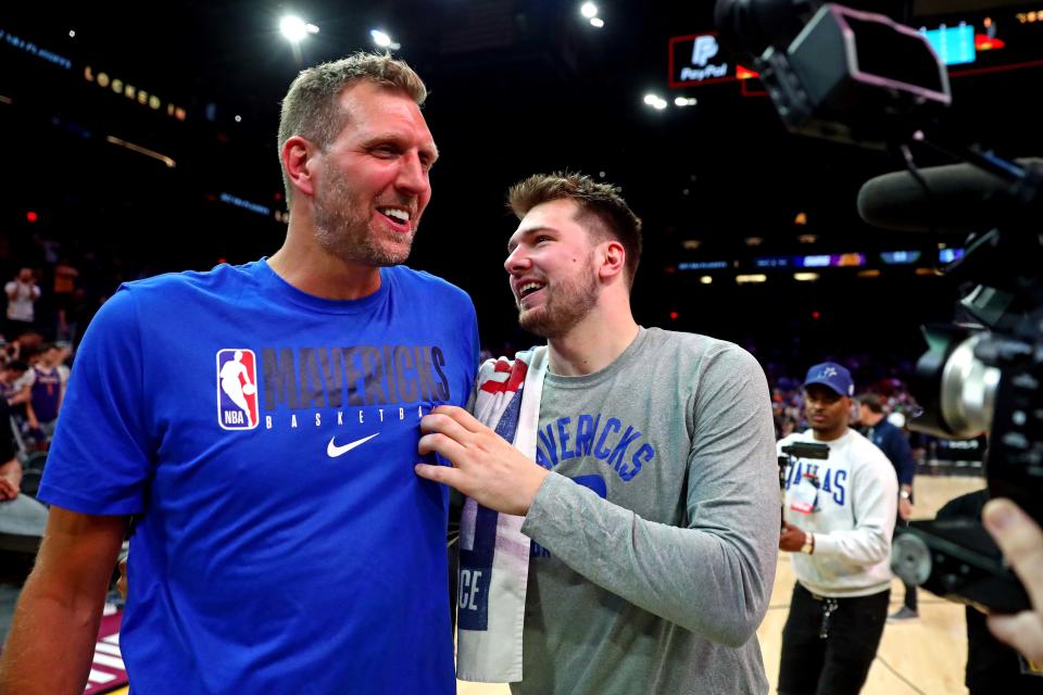 Luka Doncic greets former Mavericks player Dirk Nowitzki after defeating the Phoenix Suns in Game 7.