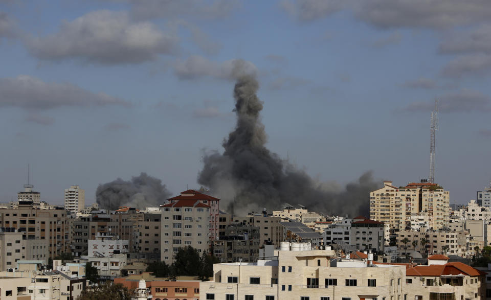 FILE - An Israeli air strike hits a building in Gaza City, May 17, 2021. Actions by Facebook and its parent Meta during last year's Gaza war violated the rights of Palestinian users to freedom of expression, freedom of assembly, political participation and non-discrimination, a report commissioned by the social media company has found. (AP Photo/Hatem Moussa, File)