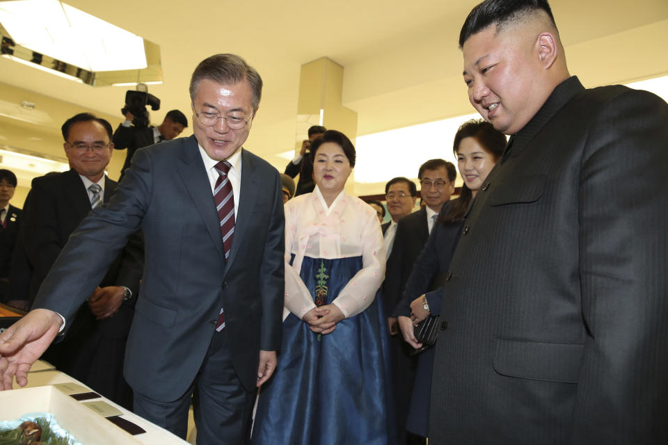 South Korean President Moon Jae-in, left, his wife Kim Jung-sook, second from left, North Korean leader Kim Jong Un and his wife Ri Sol Ju, second from right, attend a welcome banquet in Pyongyang, North Korea, Tuesday, Sept. 18, 2018. President Moon Jae-in began his third summit with North Korean leader Kim Jong Un on Tuesday with possibly his hardest mission to date — brokering some kind of compromise to keep North Korea's talks with Washington from imploding and pushing ahead with his own plans to expand economic cooperation and bring a stable peace to the Korean Peninsula. (Pyongyang Press Corps Pool via AP)