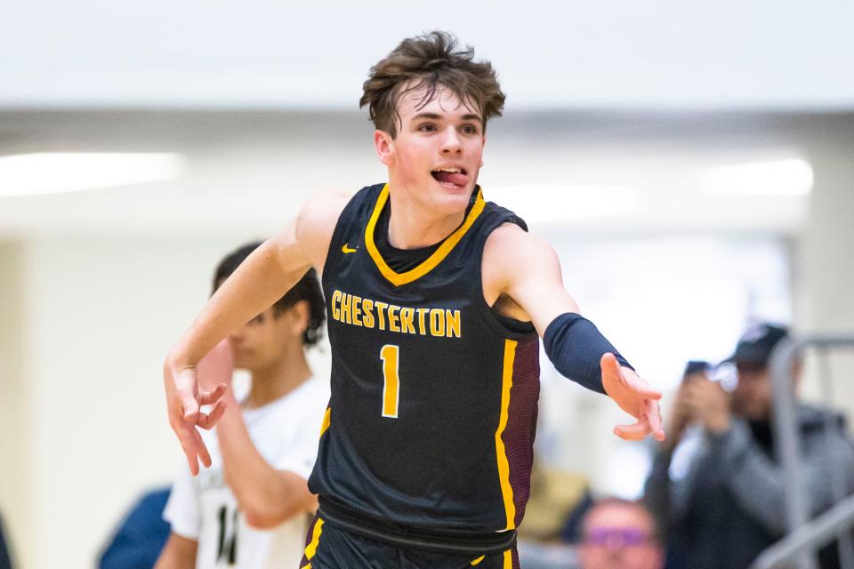 Chesterton's Tyler Parrish (1) celebrates a 3-point shot during the Penn vs. Chesterton regional championship game Saturday, March 11, 2023 at Michigan City High School.