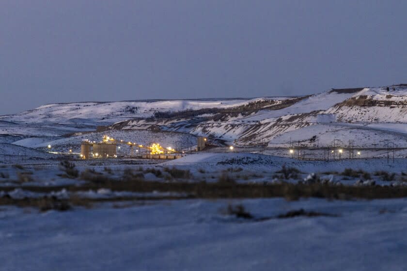 FILE - Lights illuminate a coal mine at twilight, Jan. 13, 2022, in Kemmerer, Wyo. With the nearby coal-fired Naughton Powerplant being decommissioned in 2025, the fate of the coal mine and its workers is uncertain. More than 500 days into his presidency, Joe Biden's hope for saving the Earth from the most devastating effects of climate change may not be dead. But it's not far from it after a Supreme Court ruling not only limited the Environmental Protection Agency's ability to regulate pollution by power plants, but also suggests the court is poised to block other efforts to limit the climate-wrecking fumes emitted by oil, gas and coal. (AP Photo/Natalie Behring, File)