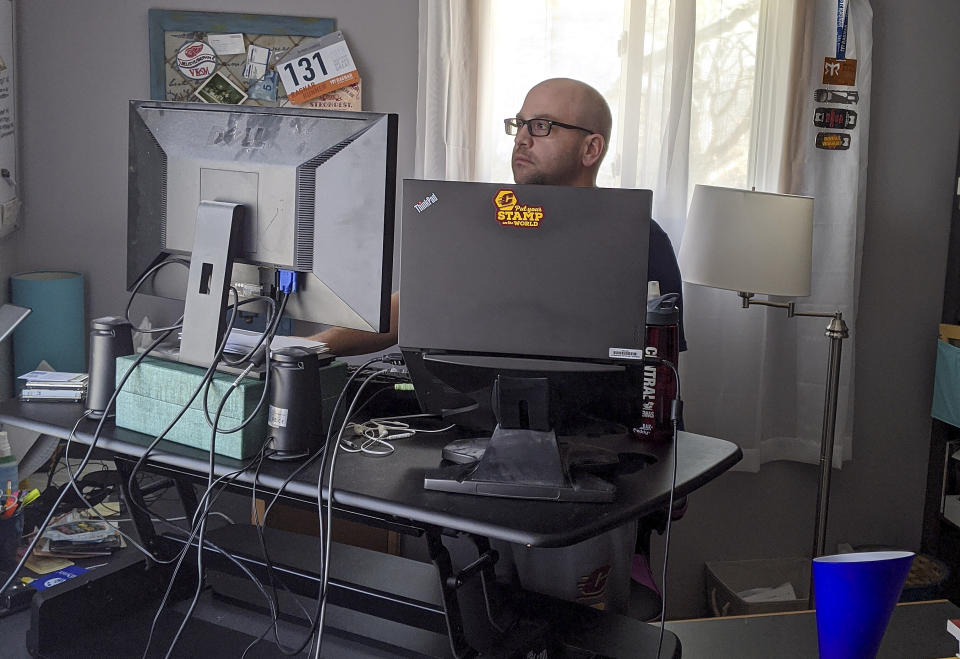 In this March 27, 2020, photo, Eric Bellmore works from his home in Mount Pleasant, Mich., while following a coronavirus-related stay at home guideline. Bellmore, who considers himself an extrovert, says it's been a struggle to adjust to a world where social interaction is highly limited. (Photo/Eric Bellmore)